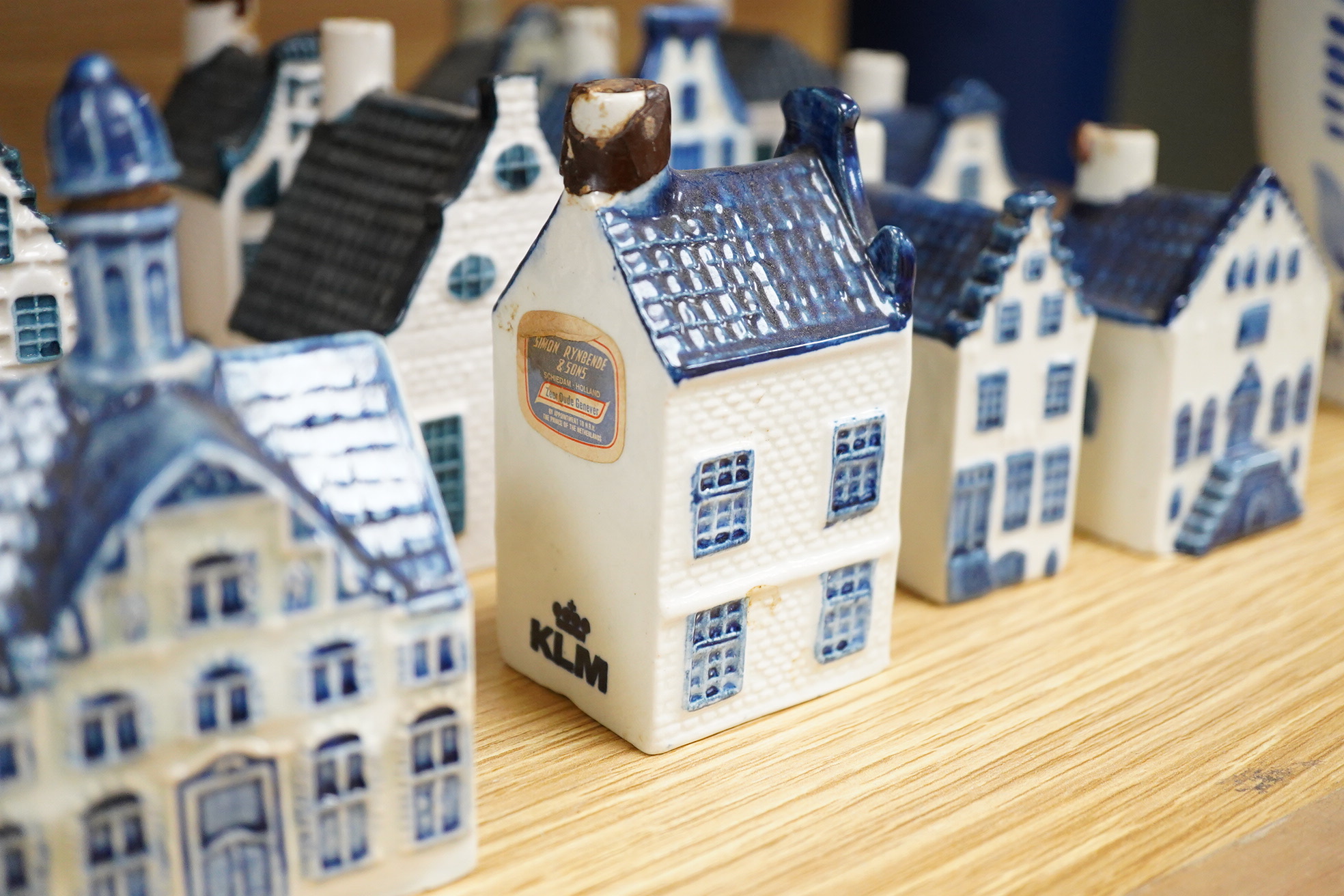 A collection of twenty seven KLM Delft blue miniature houses presented to Business class passengers together with a Delft jug - 20.5cm high